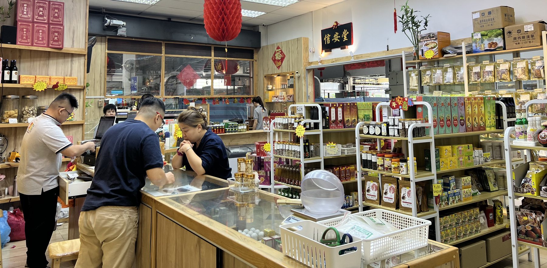 Shop floor with herbal products and staff assisting a customer